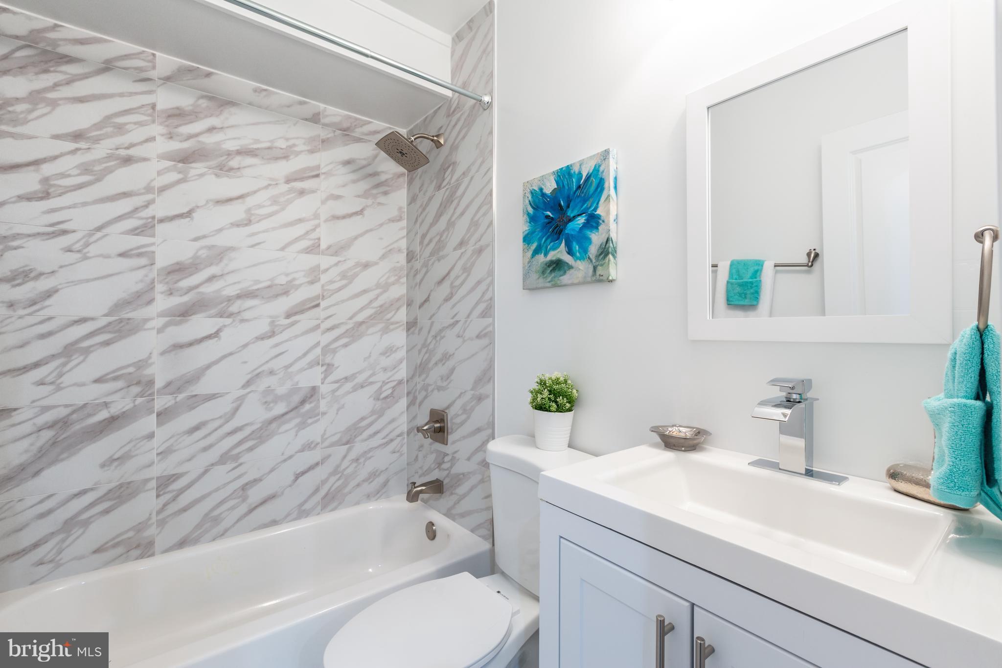 718 Jackson Street Northeast, Unit 1 Washington, DC 20017 - Photo 17 of 26 a bathroom with a sink toilet and bathtub