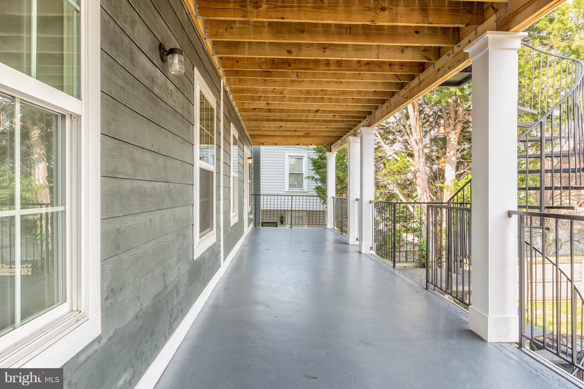718 Jackson Street Northeast, Unit 1 Washington, DC 20017 - Photo 19 of 26 a view of a porch with wooden floor and outdoor space