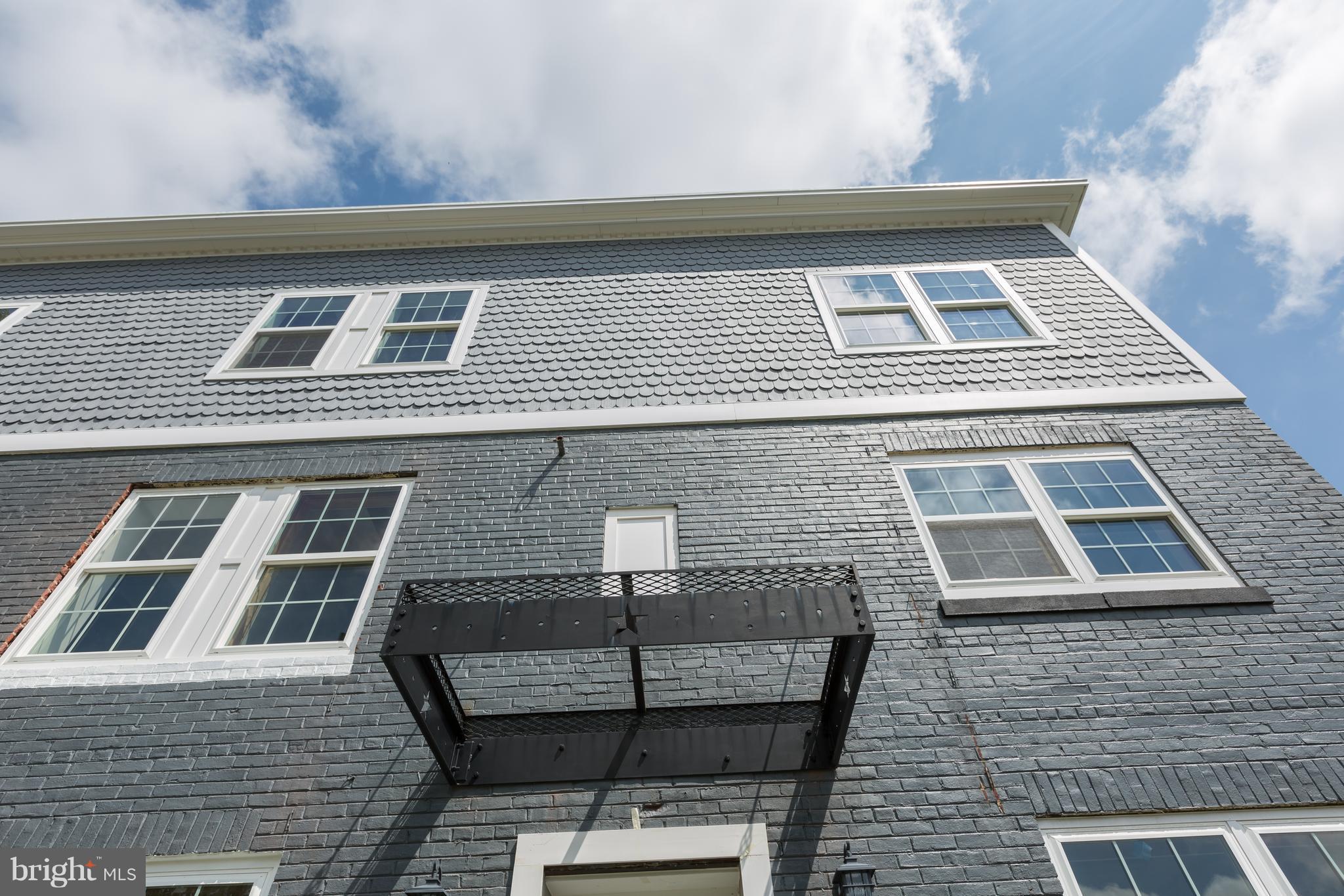 718 Jackson Street Northeast, Unit 1 Washington, DC 20017 - Photo 21 of 26 a front view of a house with a balcony