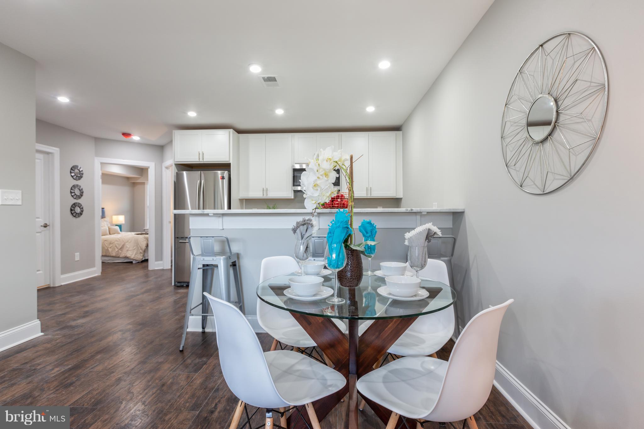 718 Jackson Street Northeast, Unit 1 Washington, DC 20017 - Photo 4 of 26 a view of a dining room with furniture window and wooden floor