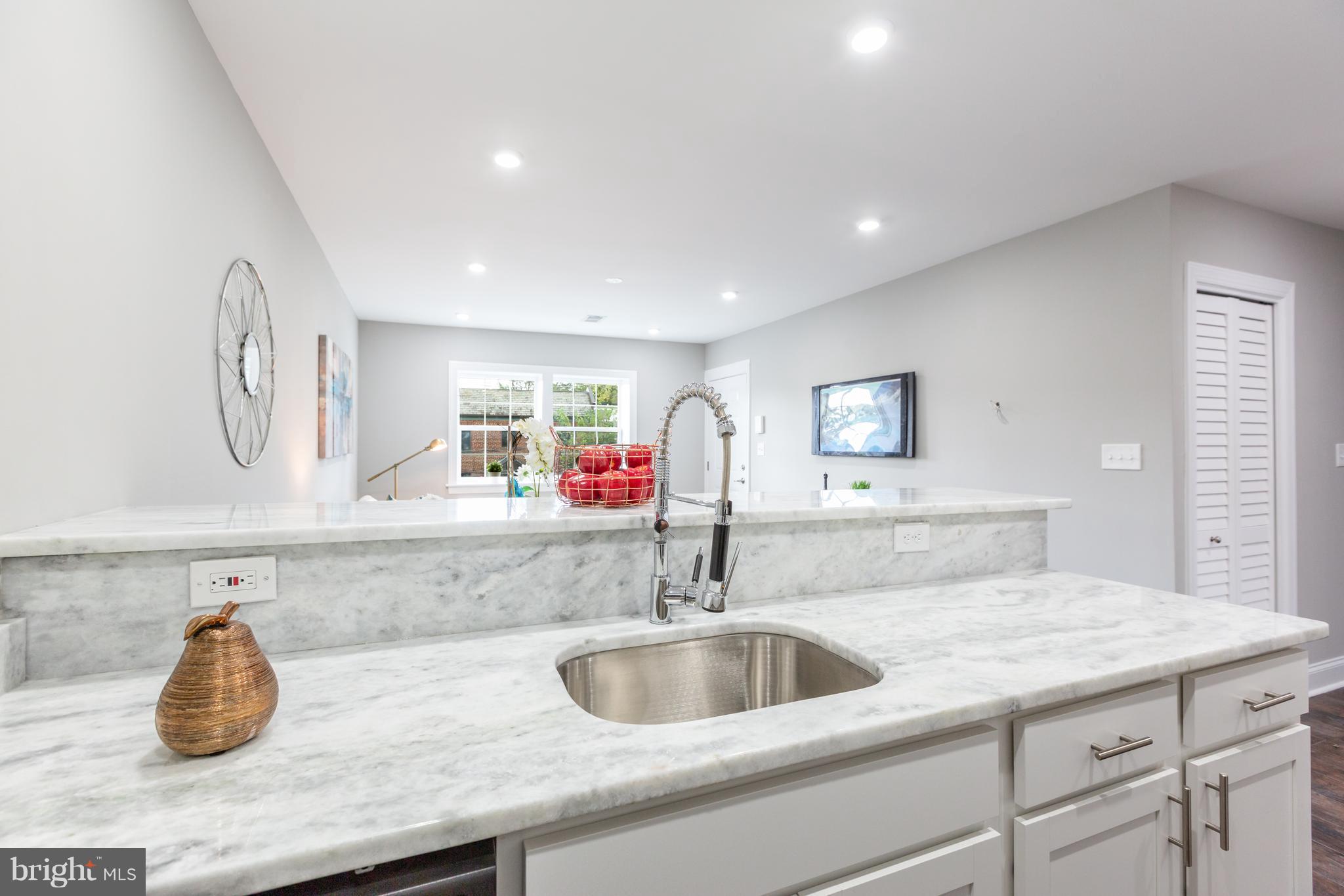 718 Jackson Street Northeast, Unit 1 Washington, DC 20017 - Photo 7 of 26 a kitchen with sink and a mirror