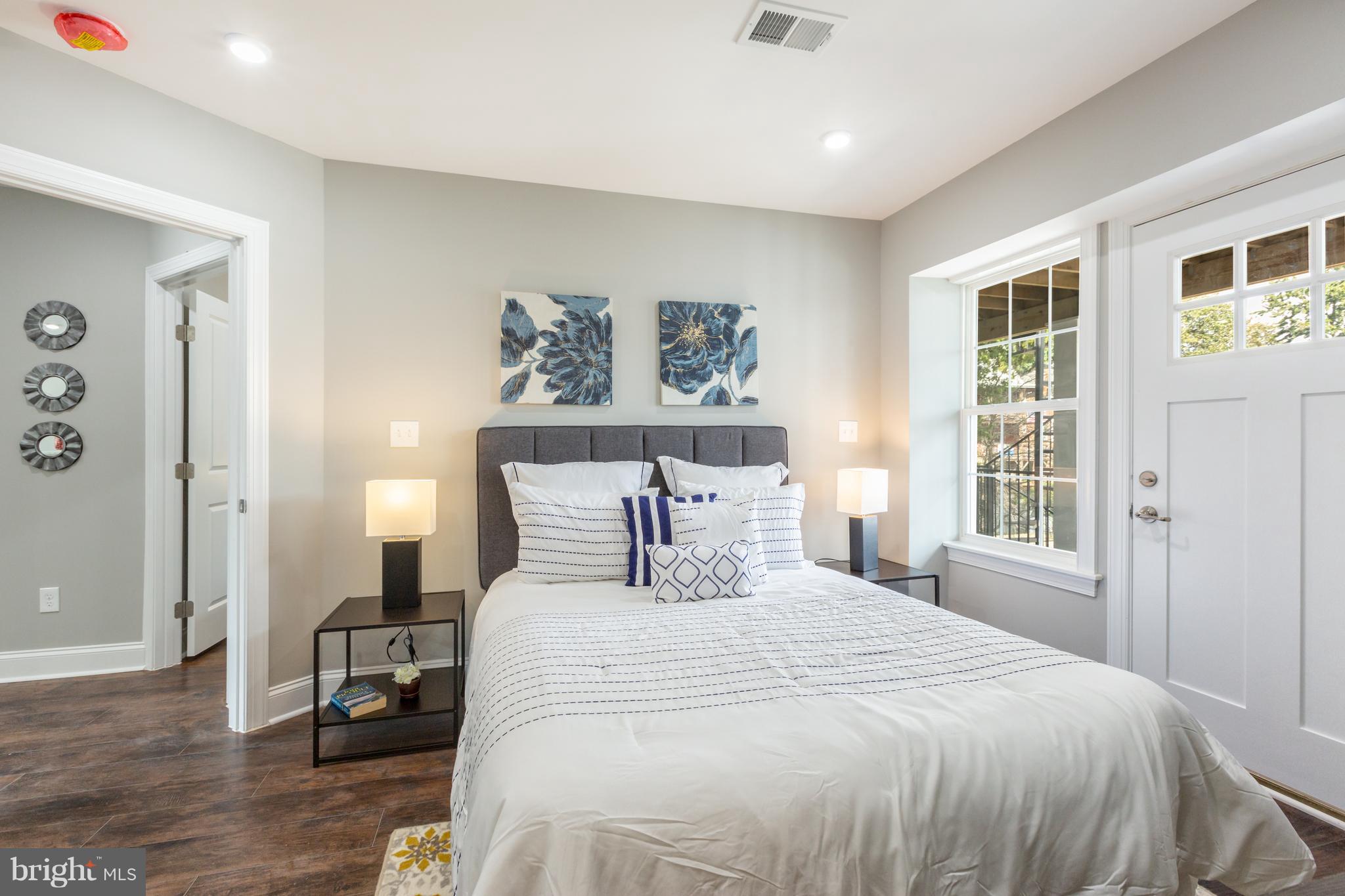 718 Jackson Street Northeast, Unit 1 Washington, DC 20017 - Photo 10 of 26 a bedroom with a large bed and a window