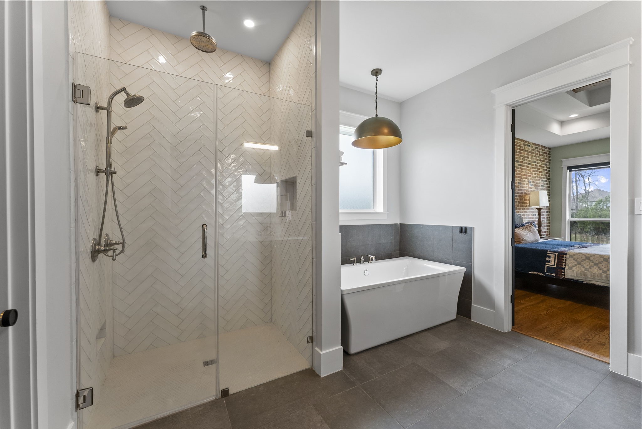 14019 Beartooth Bend Trail Conroe, TX 77384 - Photo 16 of 28 Sleek tile flooring, a floor-to-ceiling tiled shower, and a deep soaking tub create a spa-like retreat.