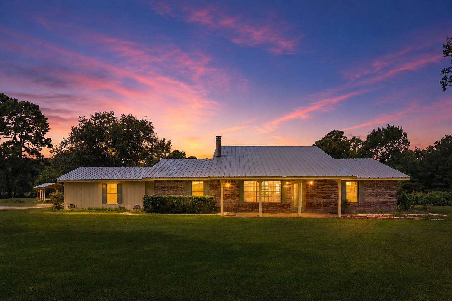 151 Parker Road New Waverly, TX 77358 - Photo 1 of 36 Experience the enchanting allure of this home, beautifully illuminated against a stunning twilight backdrop, offering a warm and inviting welcome.