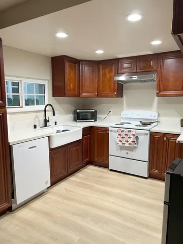 a kitchen with a sink stove and cabinets