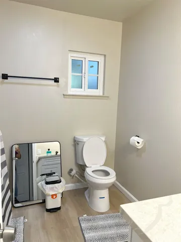 a bathroom with a toilet a sink and a mirror