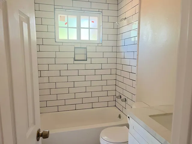 a bathroom with a toilet and a bathtub