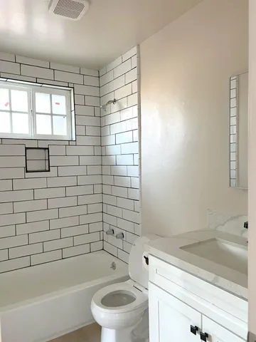 a bathroom with a bathtub and shower