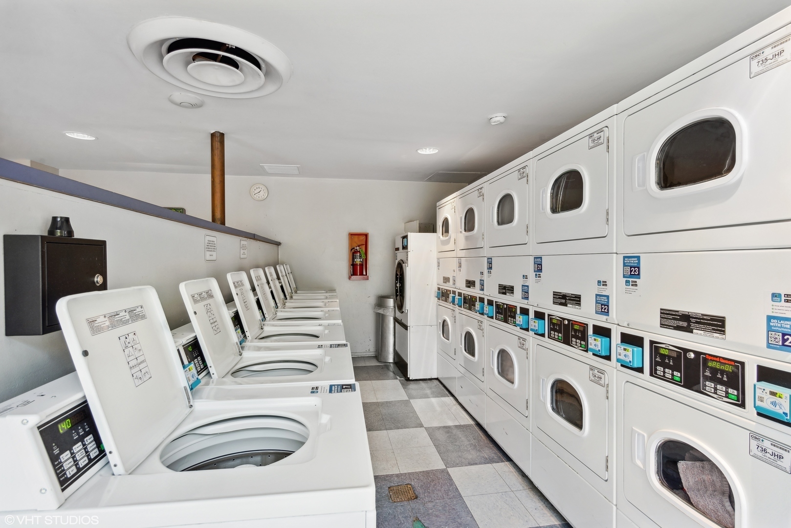 4343 North Clarendon Avenue, Unit 2613 Chicago, IL 60613 - Photo 15 of 15 a kitchen with stainless steel appliances granite countertop a white stove top oven a refrigerator and a dining table with wooden floor