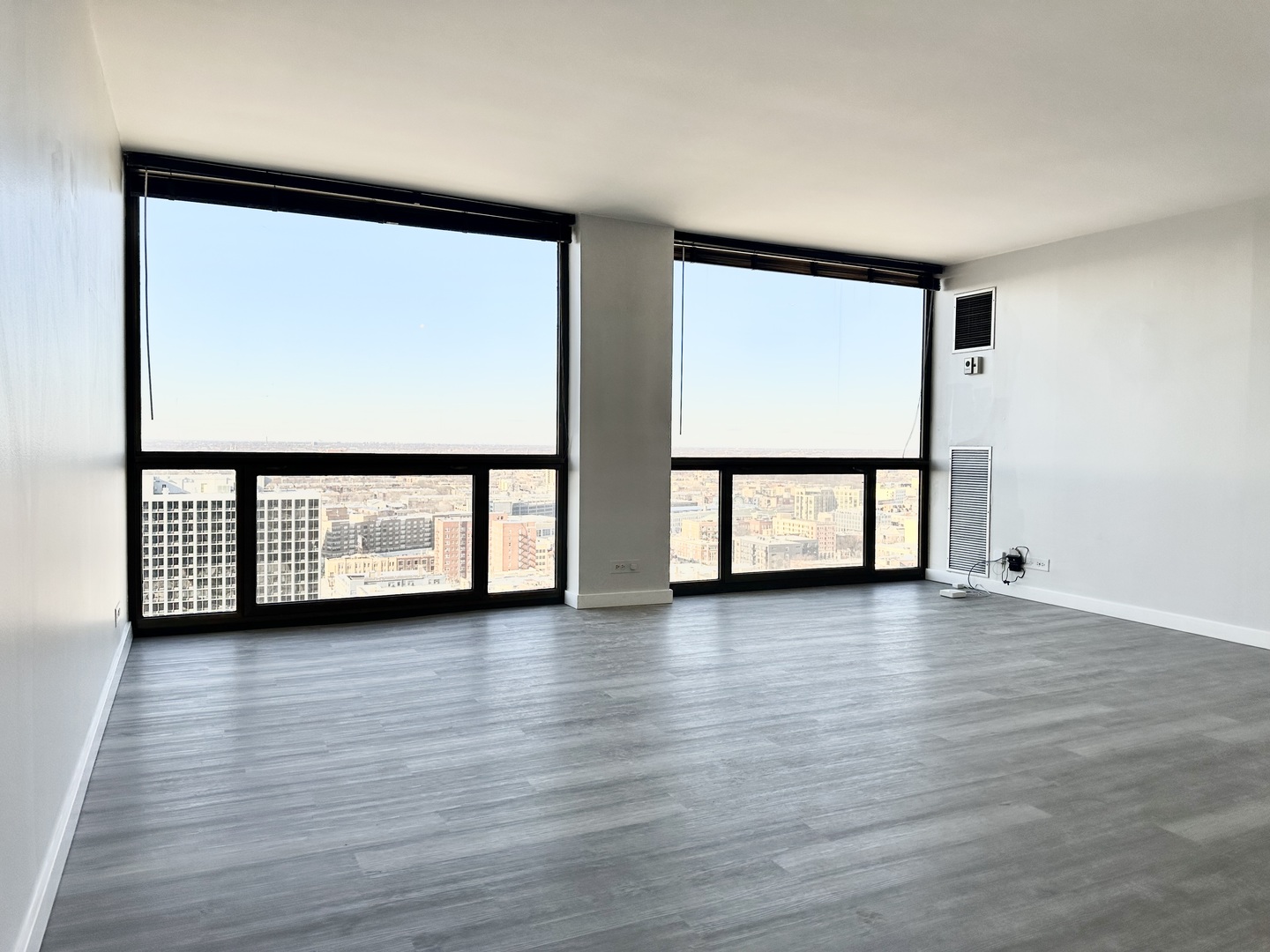 4343 North Clarendon Avenue, Unit 2613 Chicago, IL 60613 - Photo 3 of 15 a view of a room with wooden floor and windows