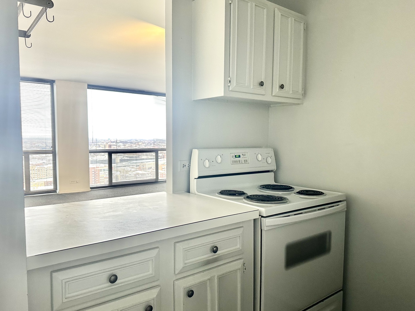 4343 North Clarendon Avenue, Unit 2613 Chicago, IL 60613 - Photo 5 of 15 a kitchen with granite countertop white cabinets and white appliances