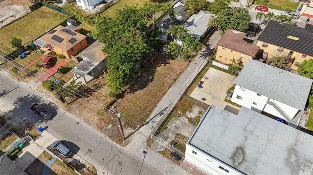 an aerial view of multiple houses with yard