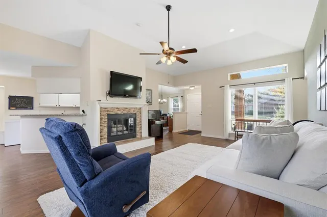 a living room with furniture a flat screen tv and a fireplace