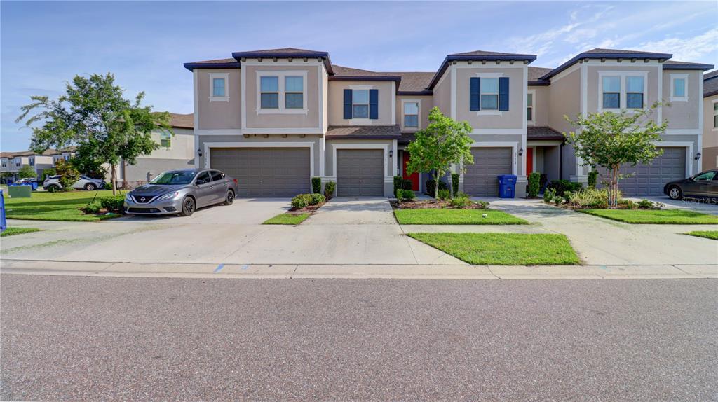31632 Blue Passing Loop Wesley Chapel, FL 33545 - Photo 1 of 48 a front view of a house with a yard and garage