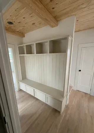 a room with a black white checkered floor with a sink and a mirror