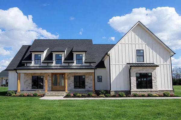 a front view of house with yard and green space