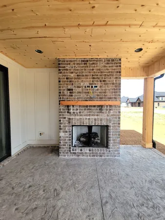 a view of an empty room with a fireplace