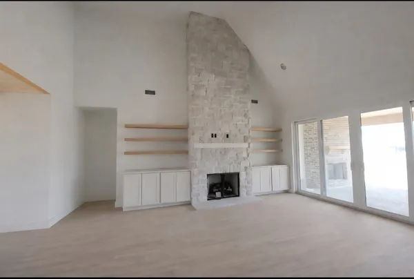 a view of empty room with a fireplace and cabinet
