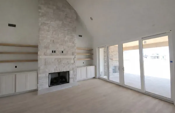 a view of empty room with a fireplace