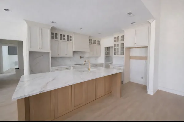 a kitchen with kitchen island a sink stainless steel appliances and cabinets
