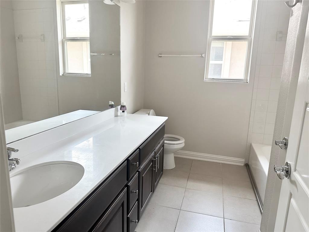6814 East Riverside Drive, Unit 26 Austin, TX 78741 - Photo 15 of 21 A well-appointed bathroom features a long vanity with dual sinks, creating a harmonious and functional space.