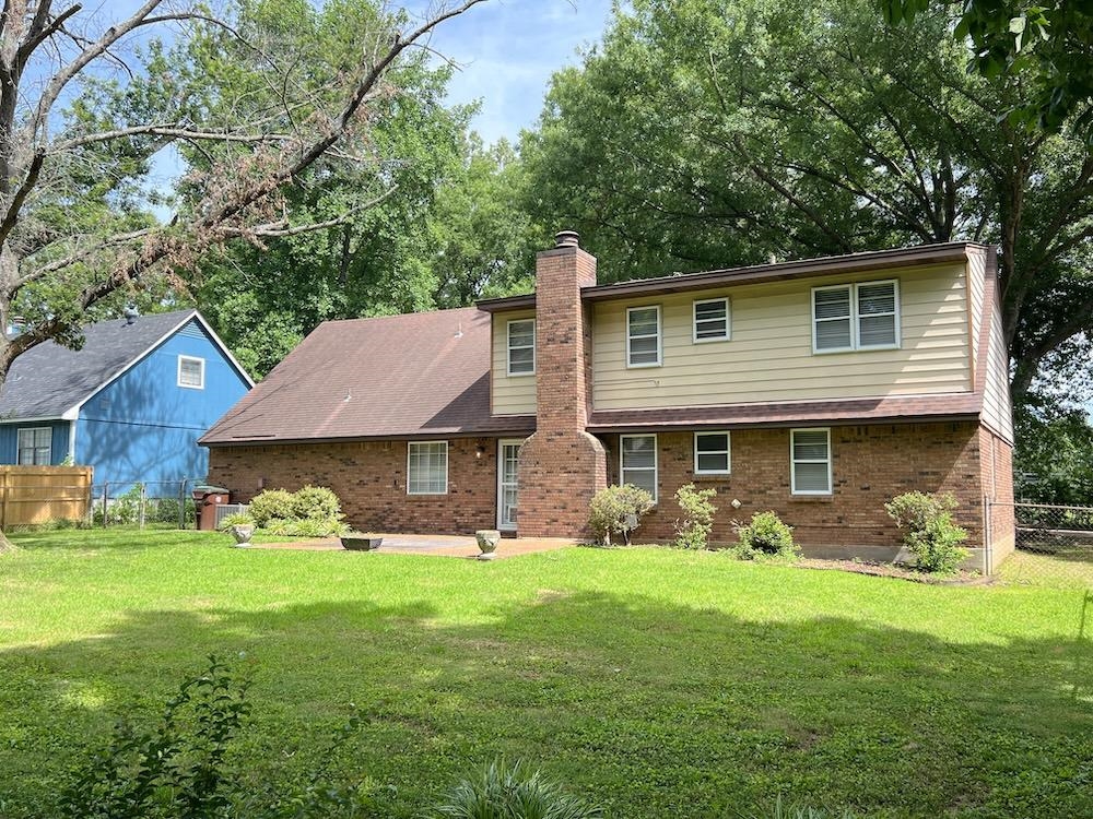 7935 Memphis Arlington Road Bartlett, TN 38133 - Photo 19 of 20 Two-story residence featuring a brick and siding exterior, a prominent chimney, and a shingle roof