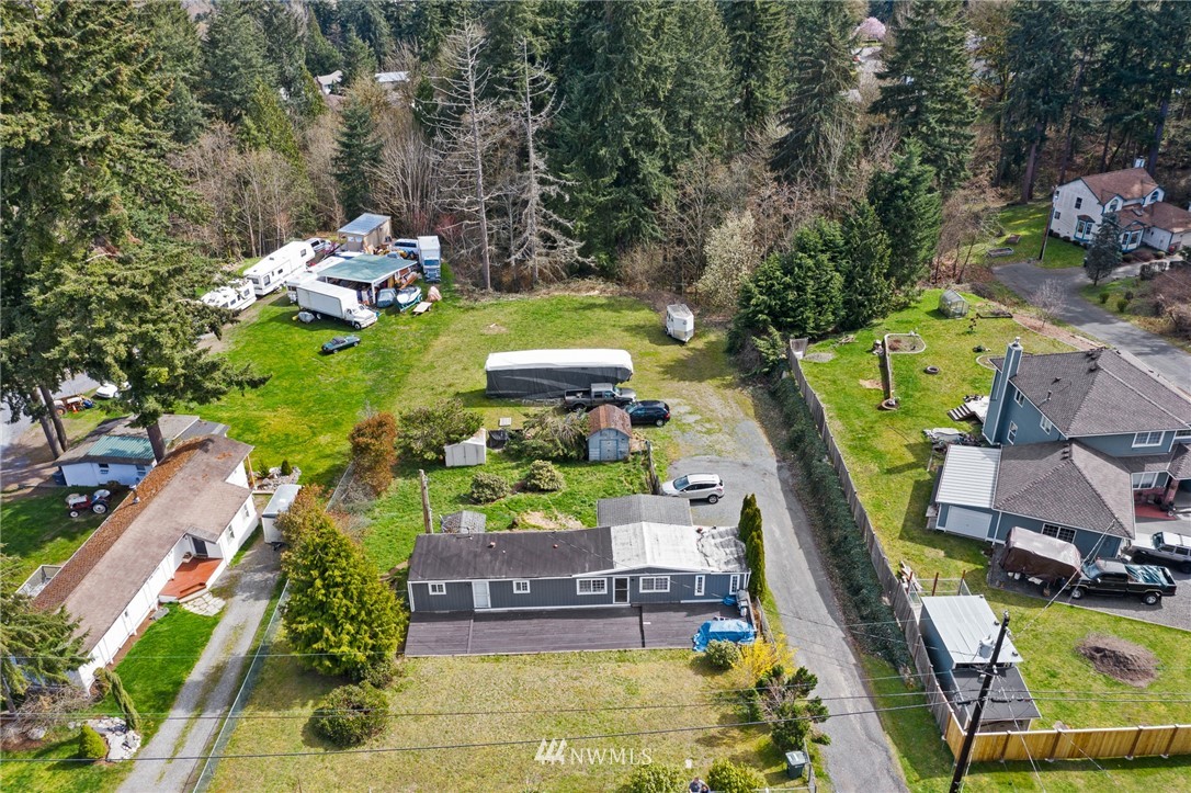 an aerial view of a house with swimming pool and garden