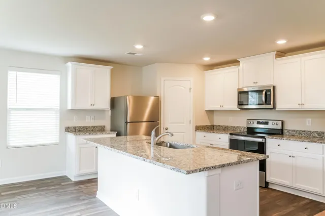 a kitchen with a refrigerator a sink and a refrigerator