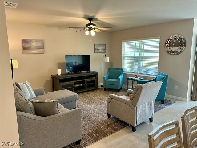 a view of a dining room with furniture and a chandelier