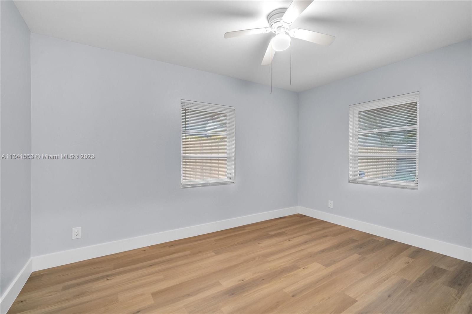 217 East 24th Street Riviera Beach, FL 33404 - Photo 13 of 27 wooden floor in an empty room with a window