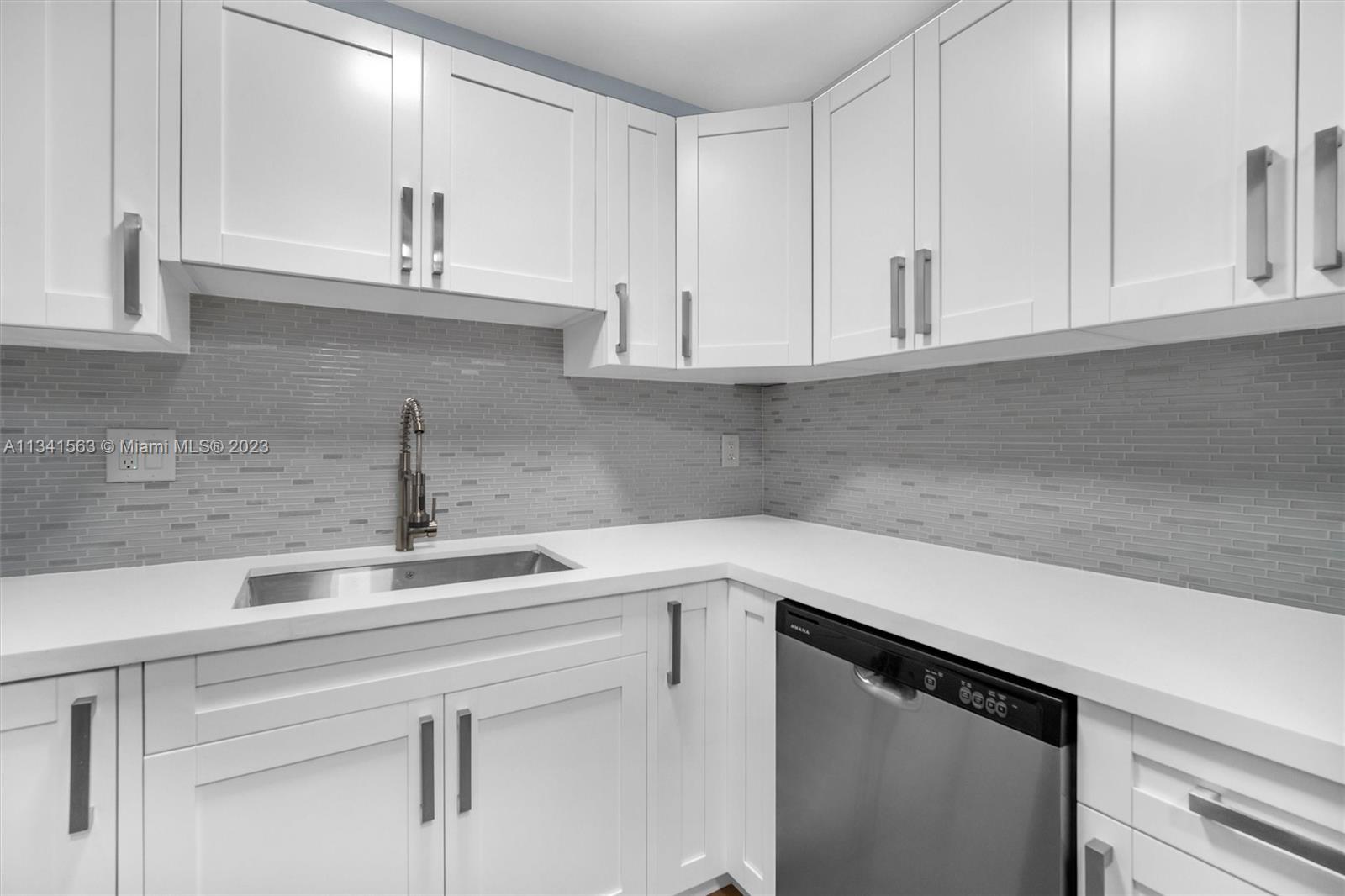 217 East 24th Street Riviera Beach, FL 33404 - Photo 5 of 27 a kitchen with a sink and cabinets