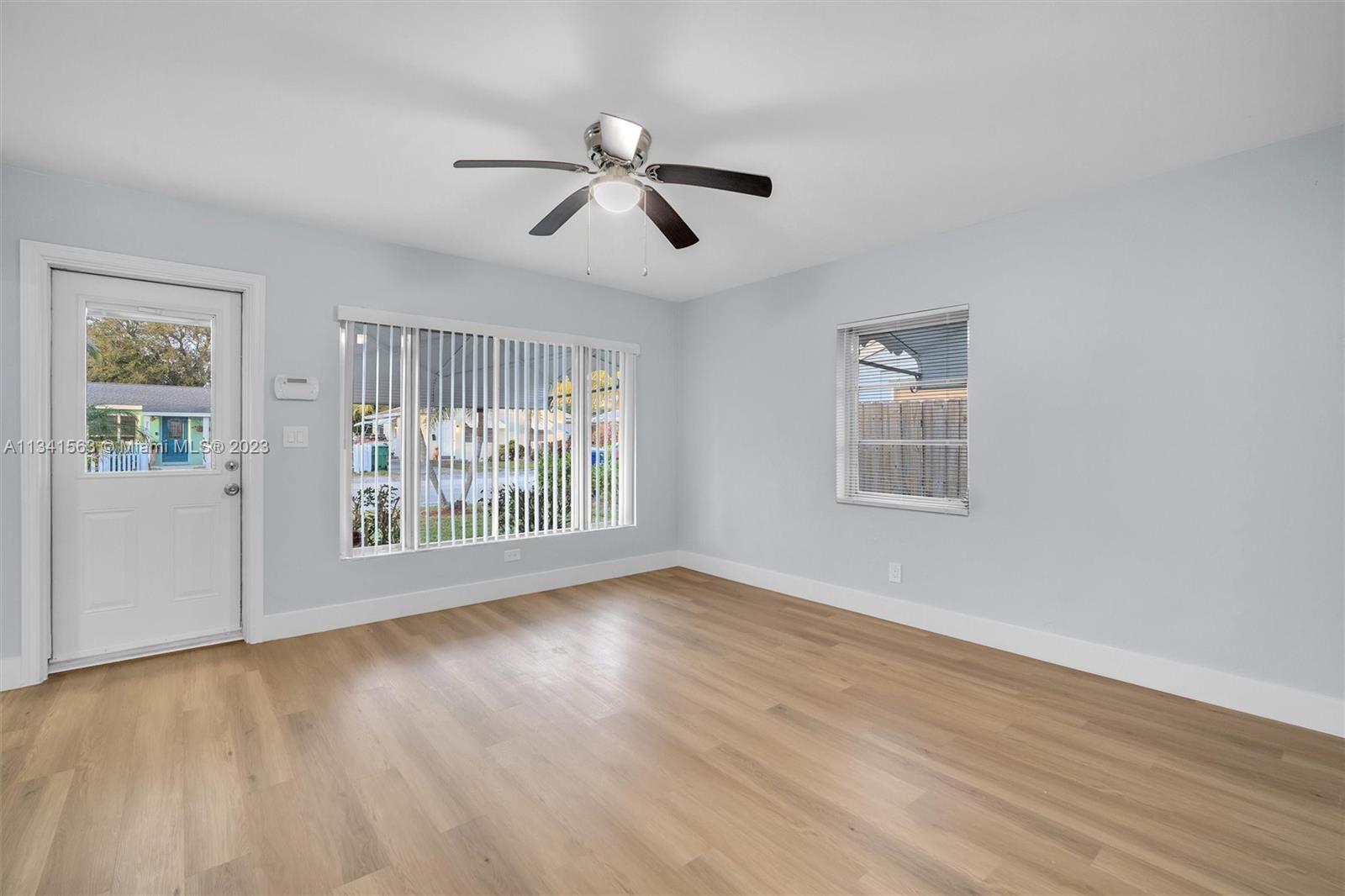 217 East 24th Street Riviera Beach, FL 33404 - Photo 6 of 27 a view of an empty room with wooden floor and a window