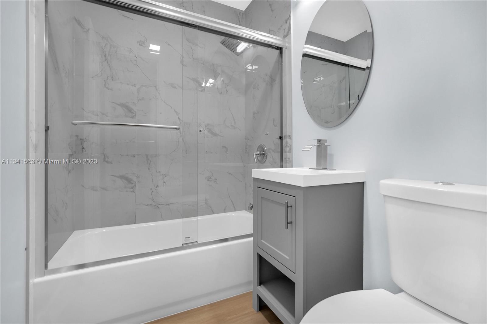 217 East 24th Street Riviera Beach, FL 33404 - Photo 7 of 27 a bathroom with a sink a toilet and a mirror