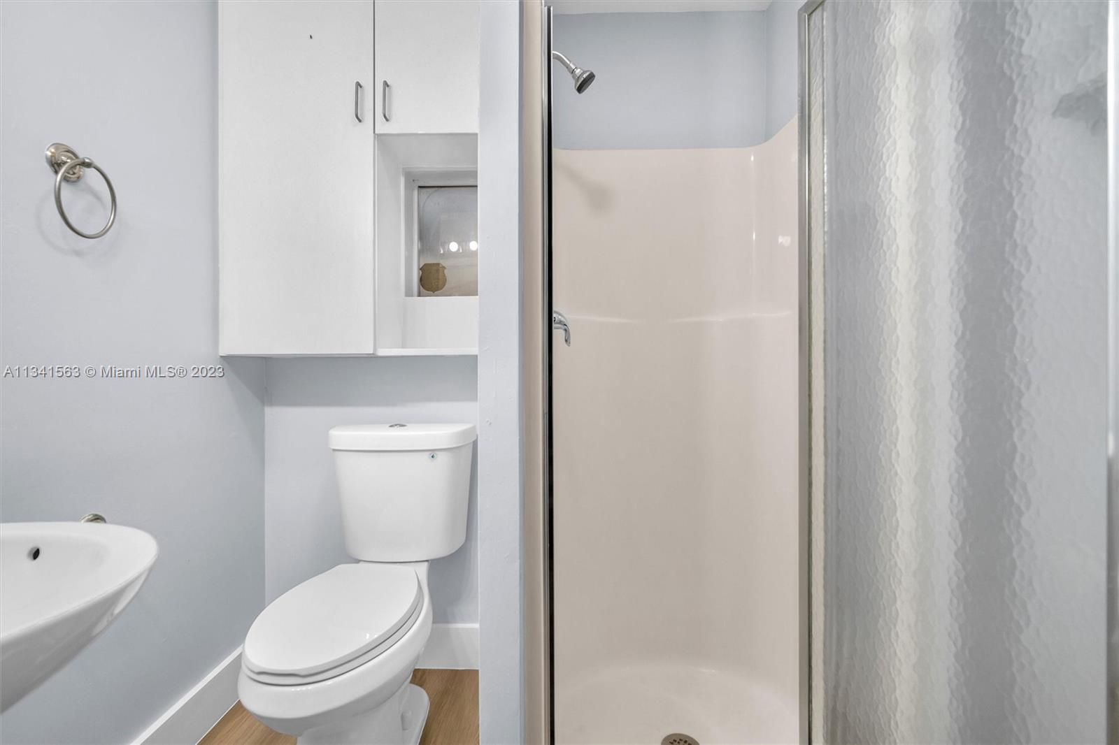 217 East 24th Street Riviera Beach, FL 33404 - Photo 9 of 27 a white toilet sitting next to a bathroom sink