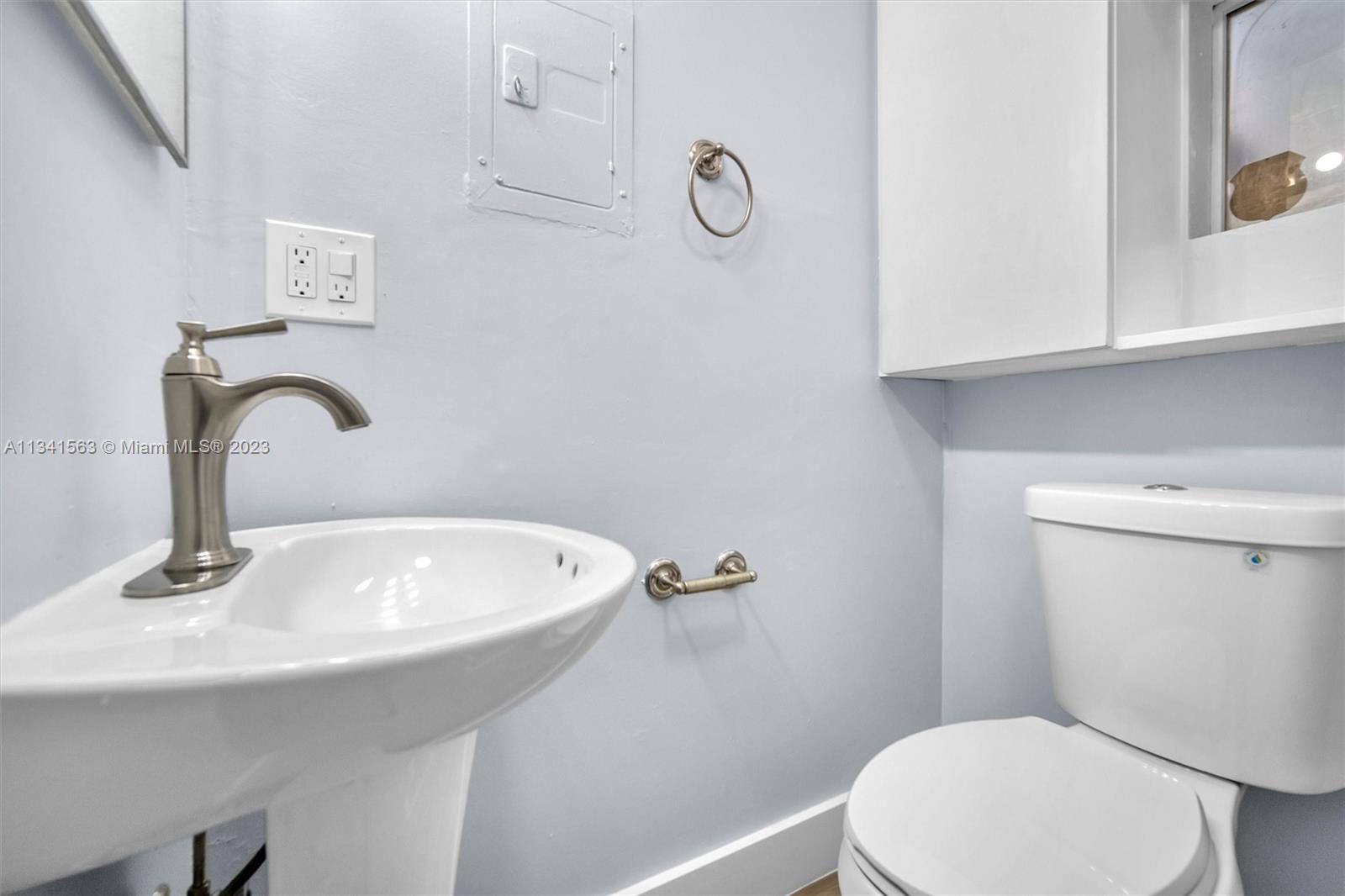217 East 24th Street Riviera Beach, FL 33404 - Photo 10 of 27 a bathroom with a sink a toilet and a mirror