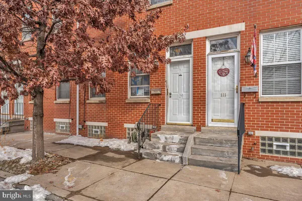 a front view of a house with a tree