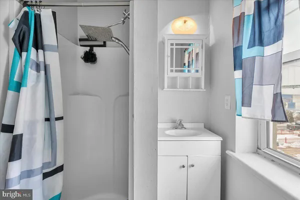 a bathroom with a sink vanity and tub