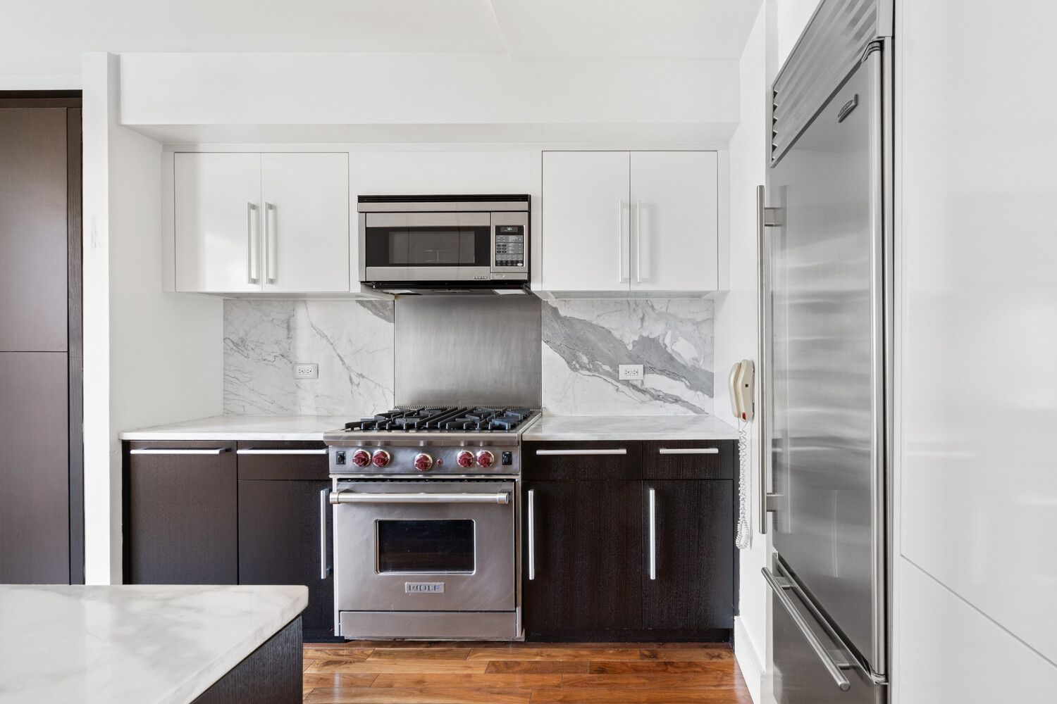 300 East 79th Street, Unit 10C Manhattan, NY 10075 - Photo 3 of 9 a kitchen with a stove and a microwave