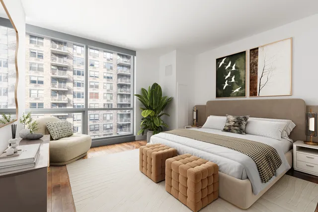 a bedroom with a bed and a couch next to a window