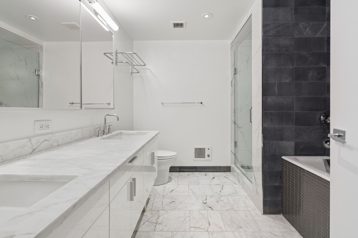 300 East 79th Street, Unit 10C Manhattan, NY 10075 - Photo 6 of 9 a bathroom with a sink a toilet and shower