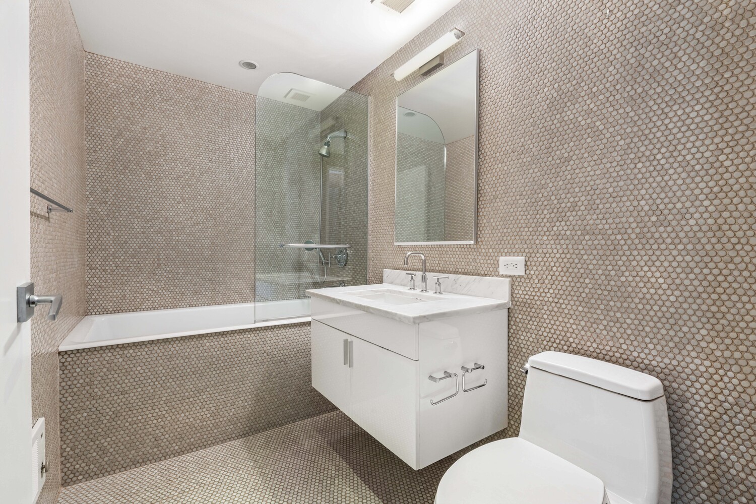 300 East 79th Street, Unit 10C Manhattan, NY 10075 - Photo 8 of 9 a bathroom with a toilet sink and mirror