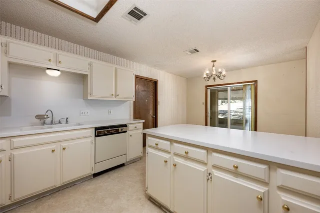 a kitchen with a refrigerator a sink and dishwasher