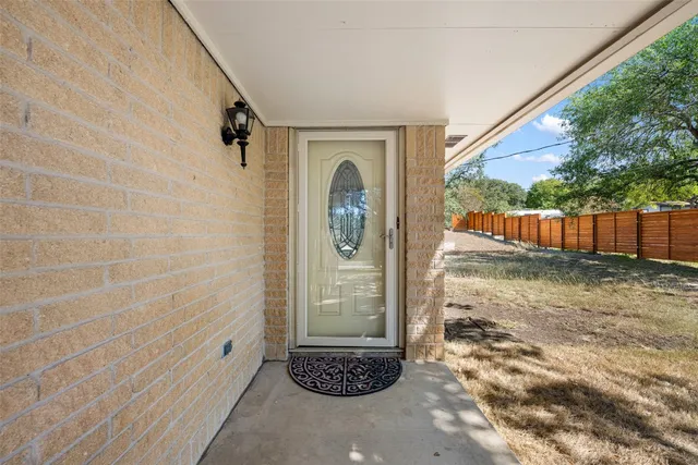 a view of a porch with furniture and floor to ceiling window