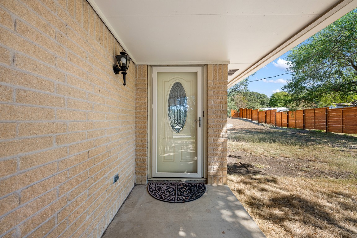 9424 El Rey Boulevard Austin, TX 78737 - Photo 3 of 35 a view of a porch with furniture and floor to ceiling window