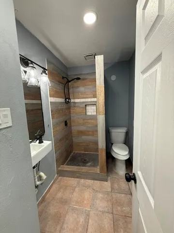 a bathroom with a toilet and a shower