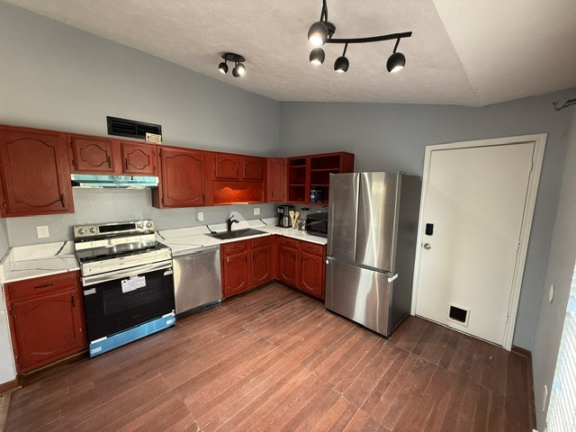 23311 Whittaker Way Spring, TX 77373 - Photo 3 of 12 a kitchen with stainless steel appliances a stove a refrigerator and a sink with wooden floor