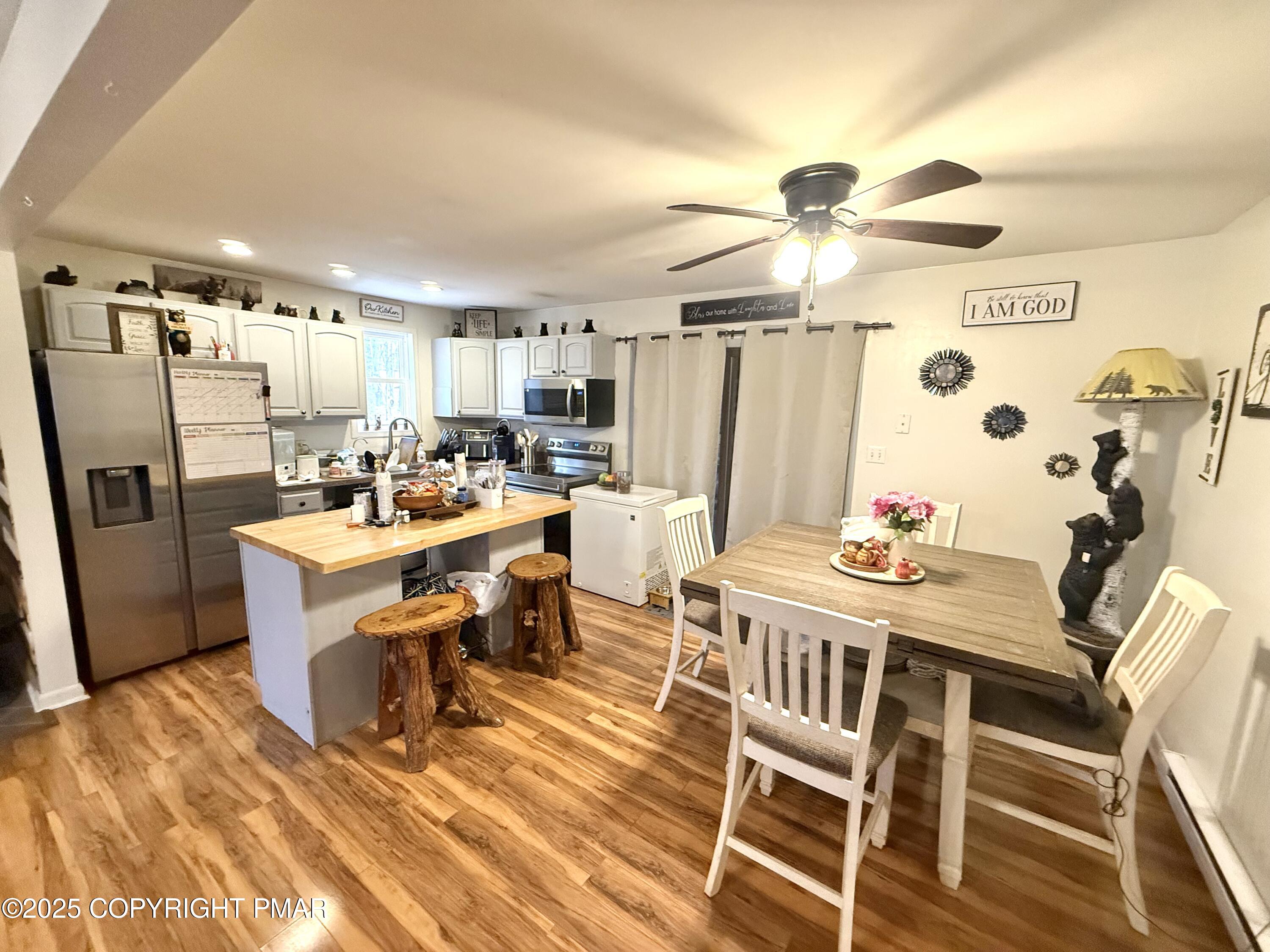 114 Maccauley Road Albrightsville, PA 18210 - Photo 8 of 21 a dining room with kitchen island stainless steel appliances furniture a rug and a chandelier