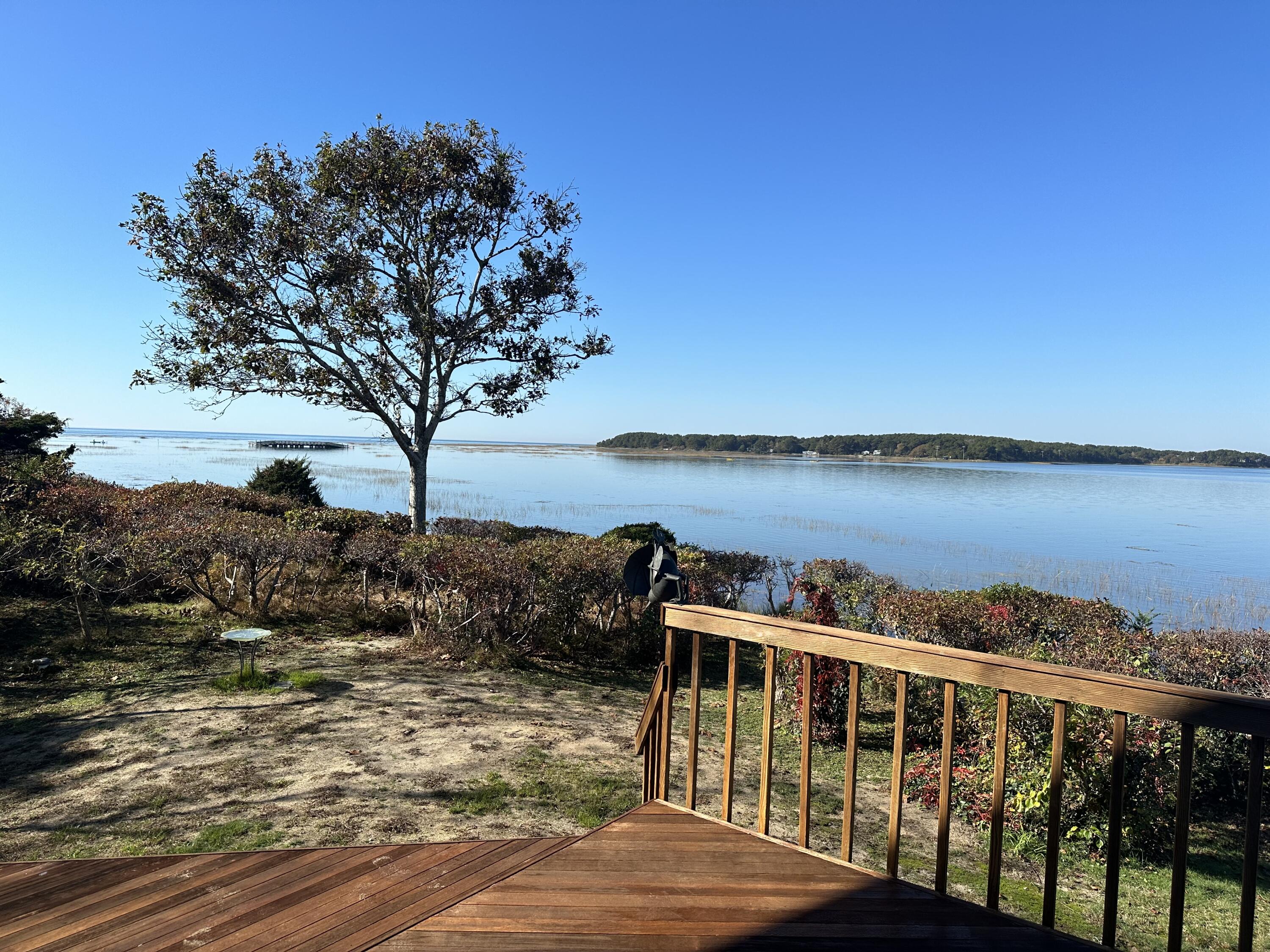 20 Catboat Road Wellfleet, MA 02667 - Photo 1 of 53 a view of a balcony with wooden chairs and lake view