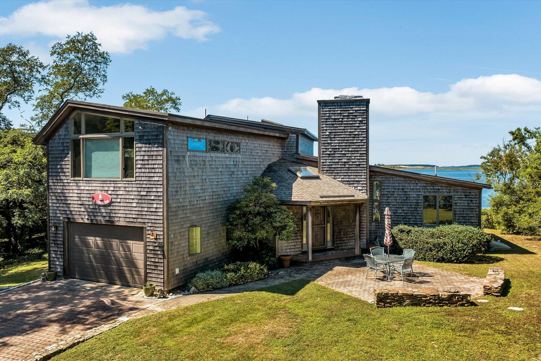 20 Catboat Road Wellfleet, MA 02667 - Photo 12 of 53 a front view of a house with a yard