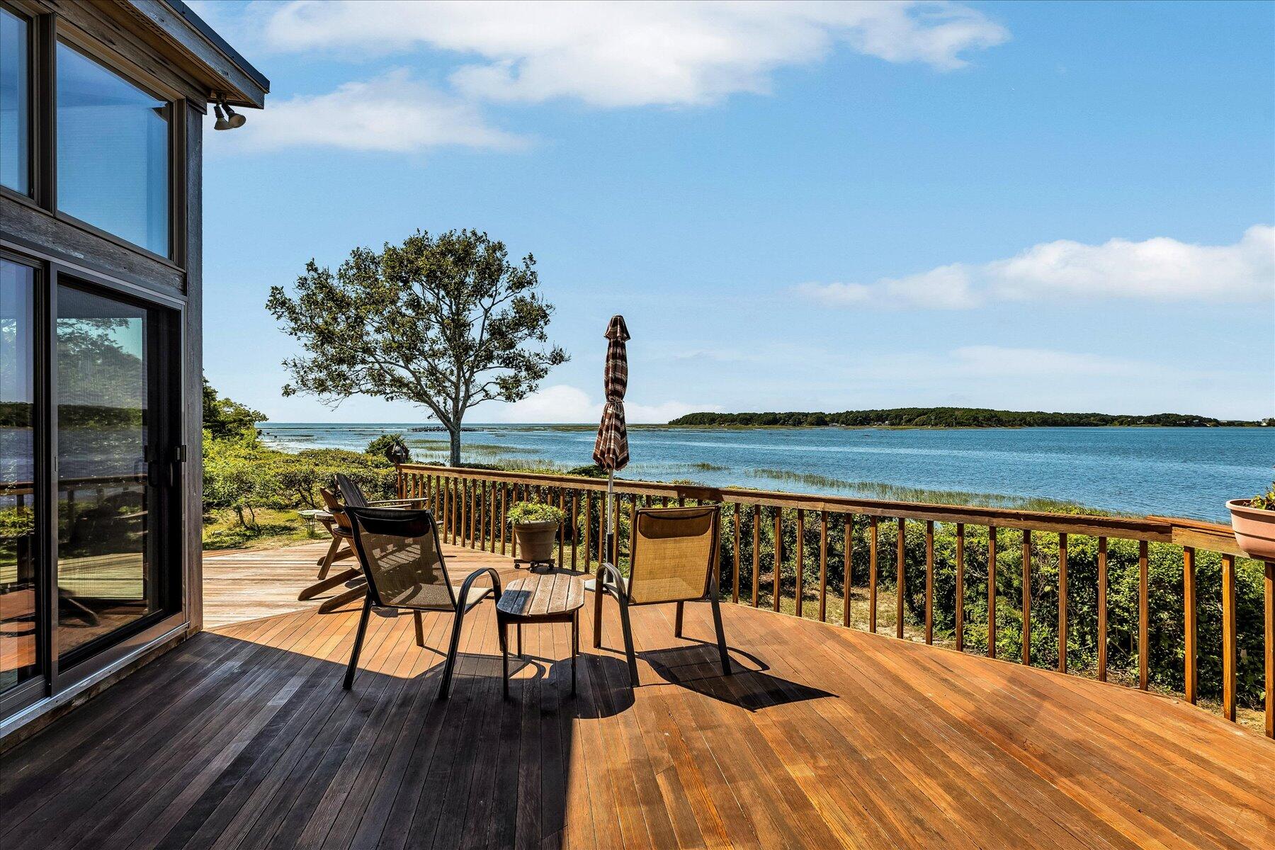 20 Catboat Road Wellfleet, MA 02667 - Photo 21 of 53 a balcony with wooden floor table and chairs